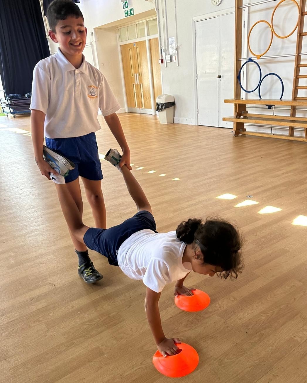 Children exercising with cones